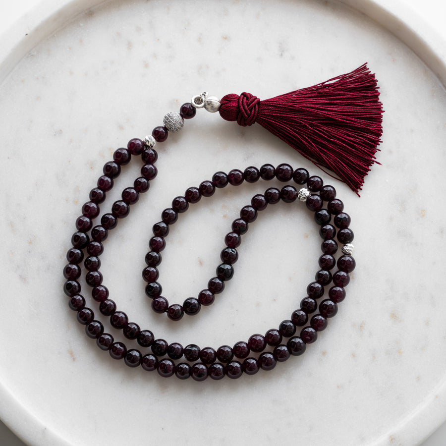 Bordeaux Quartz tasbih (misbaha) with 99 natural bordeaux quartz beads, silver separators and a burgundy tassel on white marble