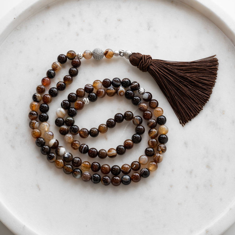 Brown Agate tasbih (misbaha) with 99 natural brown agate beads, silver separators and a brown tassel on white marble