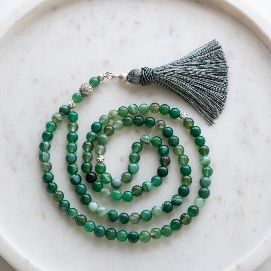 Green Agate tasbih (misbaha) with 99 natural green agate beads, silver separators and a grey tassel on white marble
