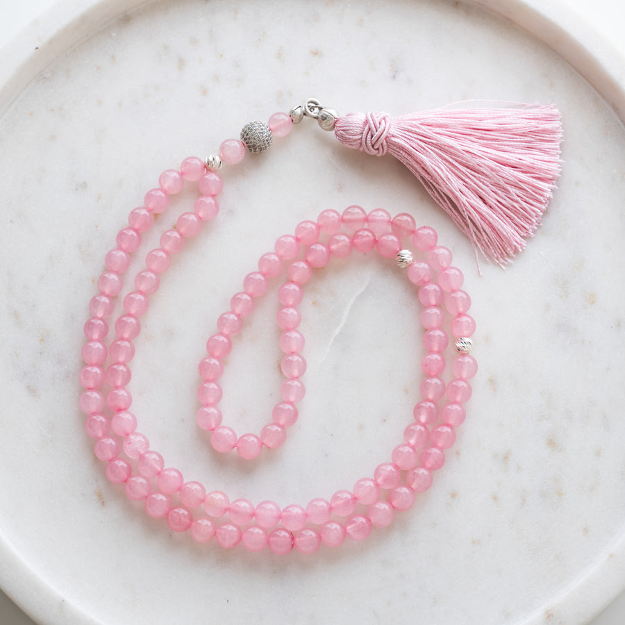 Pink Quartz tasbih (misbaha) with 99 natural pink quartz beads, silver separators and a pink tassel on white marble